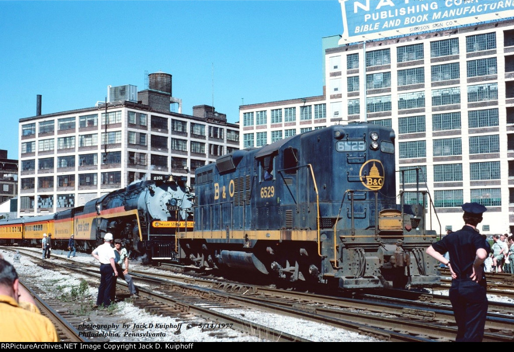 B&O GP9 6529, and Chessie Steam Special, ex-Reading T1 2101 is at Philadelphia, PA. June 14, 1977. 